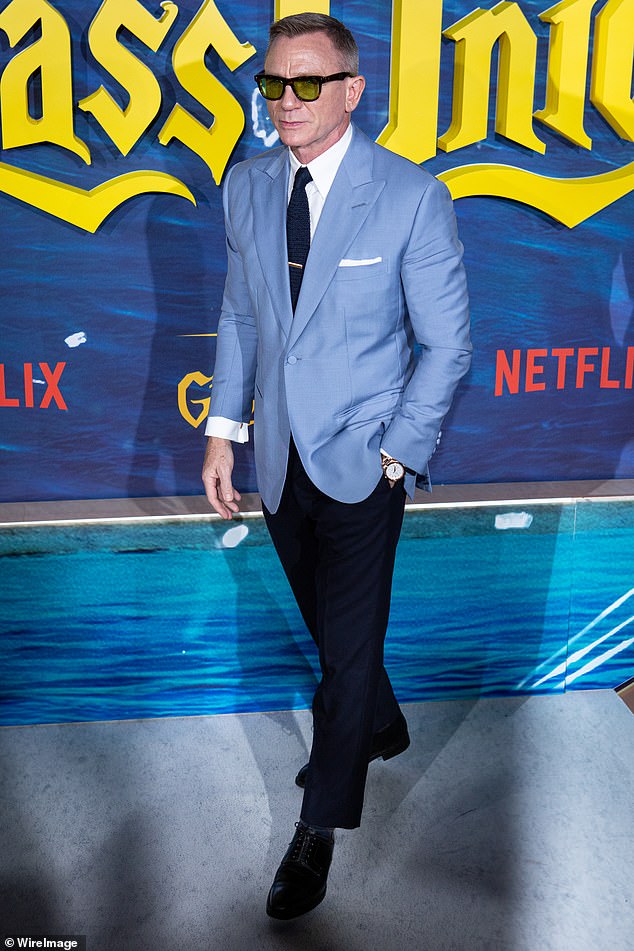Looking good: The James Bond actor, 54, dressed to impress in a smart pale blue blazer which he teamed with a pair of navy trousers