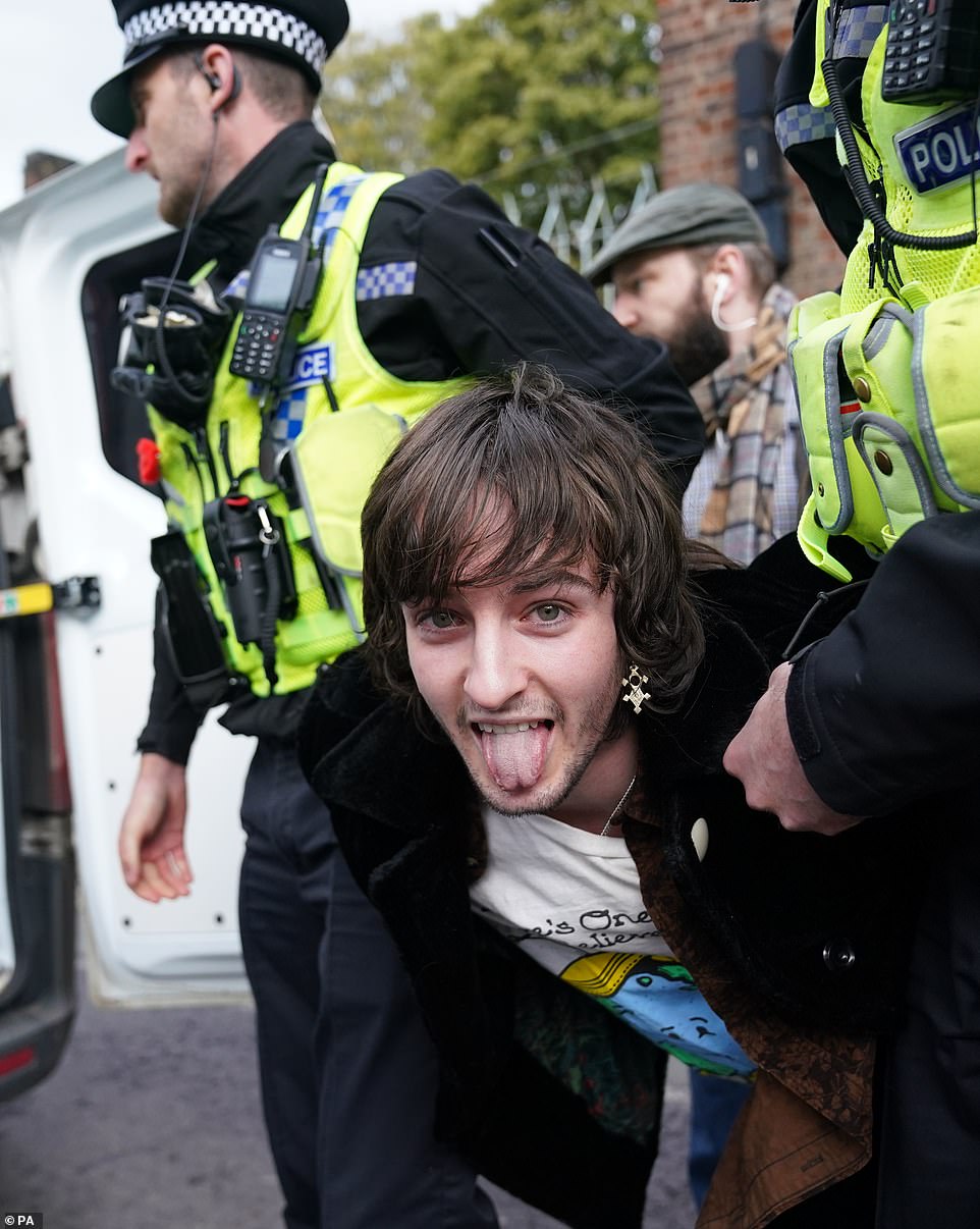 The protester shouted 'this country was built on the blood of slaves' before he was carried away by police into a waiting van